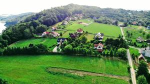 an aerial view of a village on a green hill at Dom nad Jeziorem in Mucharz +9 photos