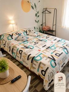 a bed with a comforter on it in a room at Donde Emma in Salamina