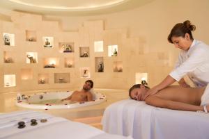 a woman laying in a bath tub with a man at Kore Tulum Retreat & Spa Resort All Inclusive - Adults Only in Tulum