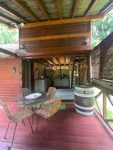 a patio with a table and chairs on a deck at Lodge Ti Zaboka , SPA Privatif in Les Abymes +32 photos