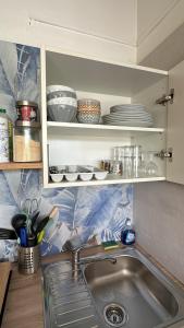 a kitchen with a sink and a counter with dishes at Le Coeur des Iles in Sainte-Anne +39 photos
