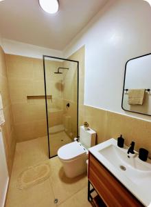 a bathroom with a toilet and a sink and a shower at Majaz Cabaña Premium Paucar in Sauce