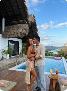 a man and a woman standing next to a swimming pool at Majaz Cabaña Premium Paucar in Sauce