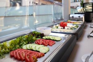 a buffet line with many different types of vegetables at Mila Sissi Bay Hotel in Sisi