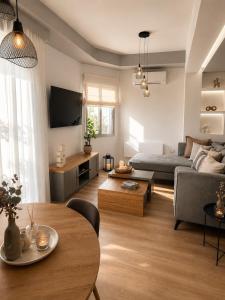 a living room with a couch and a table at NŌSSA Boutique Apartment in Naousa