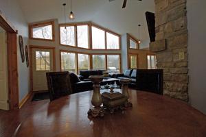 a dining room with a table and a stone wall at Summit Ridge 5 in Blue Mountains