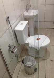 a bathroom with a toilet and a sink at M & S Hotel in Bauru