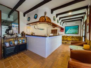 a restaurant with a white counter in a room at Hostal Costa De La Luz in Conil de la Frontera