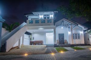 a white house at night with a staircase at Breeze 12 Villa in Negombo +35 photos