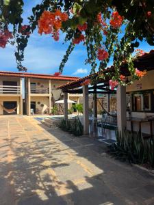 a view of the courtyard of a building with flowers at Solar DorisMar in Luis Correia