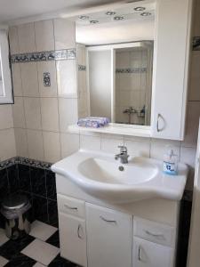 a bathroom with a white sink and a mirror at Kolhida home in Kilkis +13 photos