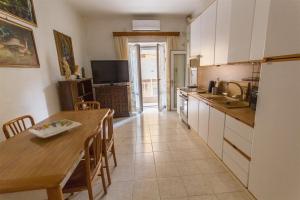 a kitchen with a table and a dining room at Brezza dell'Argentario in Porto Santo Stefano