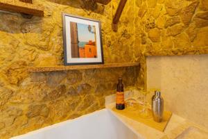 a bottle of wine sitting on a counter in a stone wall at Casa Limão in Charneca +15 photos