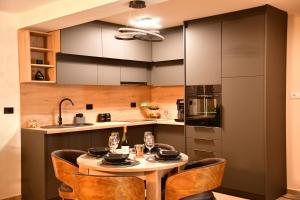 a kitchen with a table and chairs in a room at Politon Suites in Zaječar +12 photos