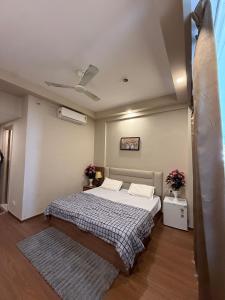 a bedroom with a bed and a ceiling at stay elan in Greater Noida