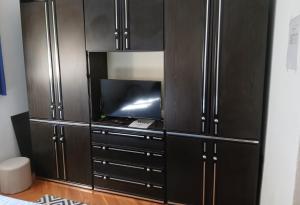 a large black cabinet with a tv in it at Аpartman CACA in Pančevo