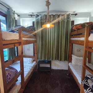 a room with three bunk beds and a window at Bunkar house in Tosh