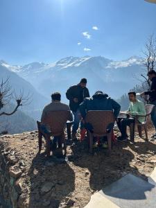 a group of people sitting in chairs on top of a mountain at Bunkar house in Tosh +9 photos
