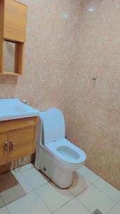 a bathroom with a toilet and a sink at أمواج البحر حي البوادي in Jeddah