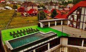a building with a green lawn on top of it at Villa Nikoletta SPA in Bukovel