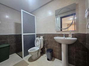 a bathroom with a toilet and a sink and a mirror at Le Diamant in Tétouan