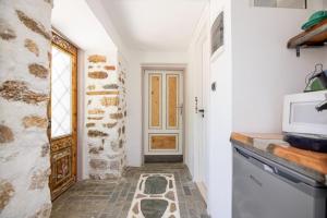 a kitchen with a door and a tile floor at Villa Sofia in Evkarpía