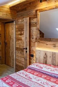 a bedroom with a bed and a mirror at Bertuzzi Homes in Aprica