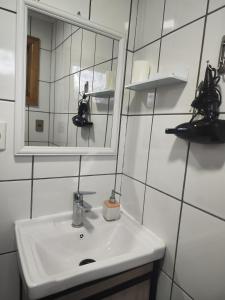 a bathroom with a sink and a mirror at Cabañas Campestres Las Rosas in Punta Arenas +60 photos