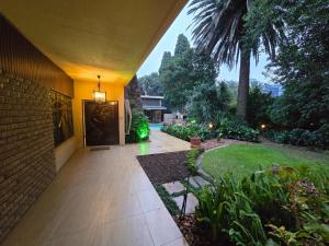 a house with a walkway leading to a yard at 27A on Angus in Johannesburg