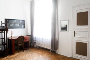 a room with a desk and a door and a table at Coffee Home Hostel in Lviv