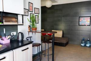 a kitchen with a bar with a couch in the background at Coffee Home Hostel in Lviv