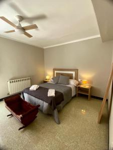 a bedroom with a bed and a ceiling fan at Ca Muns Pares in Ginestar
