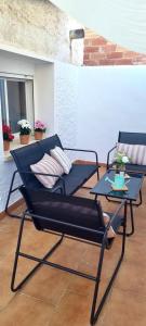 two chairs and a table on a patio at Ca Muns Pares in Ginestar