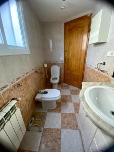 a bathroom with a toilet and a sink at Ca Muns Pares in Ginestar +18 photos