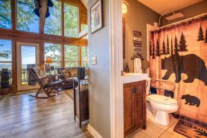 a home bathroom with a cow shower curtain and a toilet at Spectacular Mountain View - Cloud 9 - HotTub-PETS OK in Cleveland +80 photos