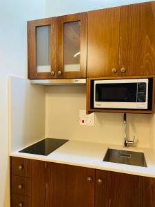 a kitchen with a sink and a microwave at Kalavasos Xenia in Kalavasos