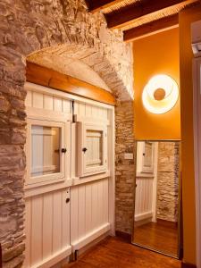 a garage with a stone wall and a white garage door at Kalavasos Xenia in Kalavasos