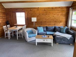 a living room with a couch and a table at Haus der Sinne in Buddenhagen