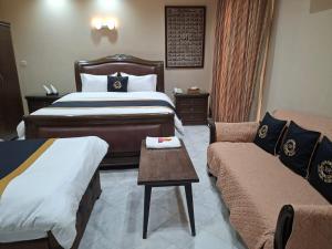 a hotel room with a bed and a couch at HOTEL STATE RESIDENCY in Bahawalpur