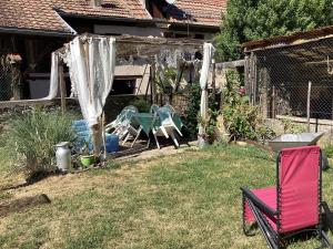 a yard with a playground with chairs and a fence at Vincenzo le cyclo in Kientzheim +2 photos