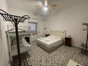 a bedroom with a bed and a ceiling fan at B&B Al Vecchio Glicine in Torre Canne