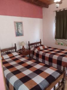 a bedroom with two beds and a picture on the wall at El Espinillo 2 in La Falda +24 photos