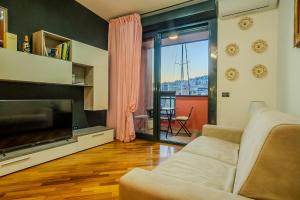 a living room with a couch and a television at SOPRA il MARE con KATE in Genoa