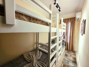 a bedroom with bunk beds in a room at Rahaf palm beach chalet in Ain Sokhna +52 photos