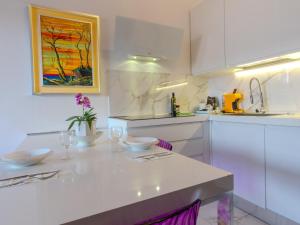 a kitchen with white cabinets and a white counter top at SOPRA il MARE con KATE in Genoa +34 photos