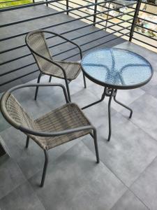 two chairs and a glass table on a balcony at Apartament Matki Polki II in Łódź +12 photos