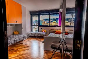 a room with two beds and a large window at SOPRA il MARE con KATE in Genoa