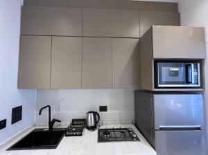 a kitchen with a stove and a microwave at Bader home in Cairo