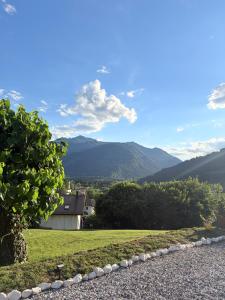 a view of a house with mountains in the background at Everest Experience in Paluzza +15 photos