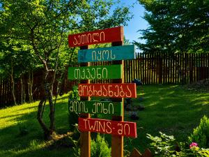 a street sign with many different signs in a yard at Mtis qokhi Twins in Mtskheta